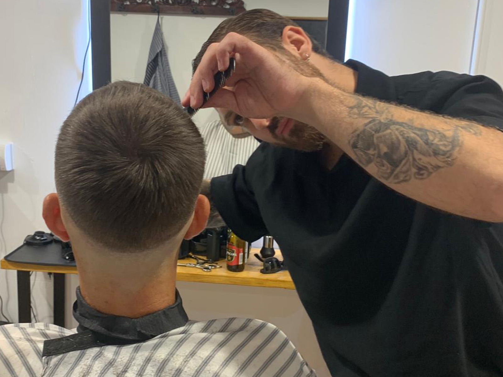 Client with a fresh cut at Short Cuts Barbershop