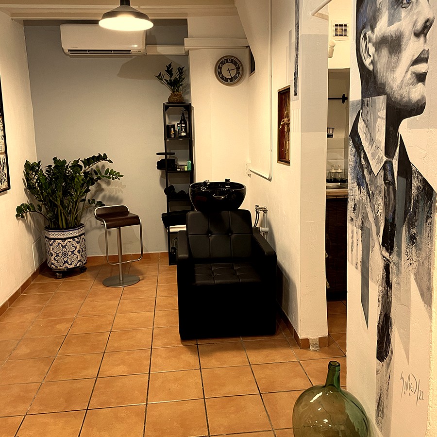 Short Cuts Barbershop wash station and Peaky Blinders mural in warm low light